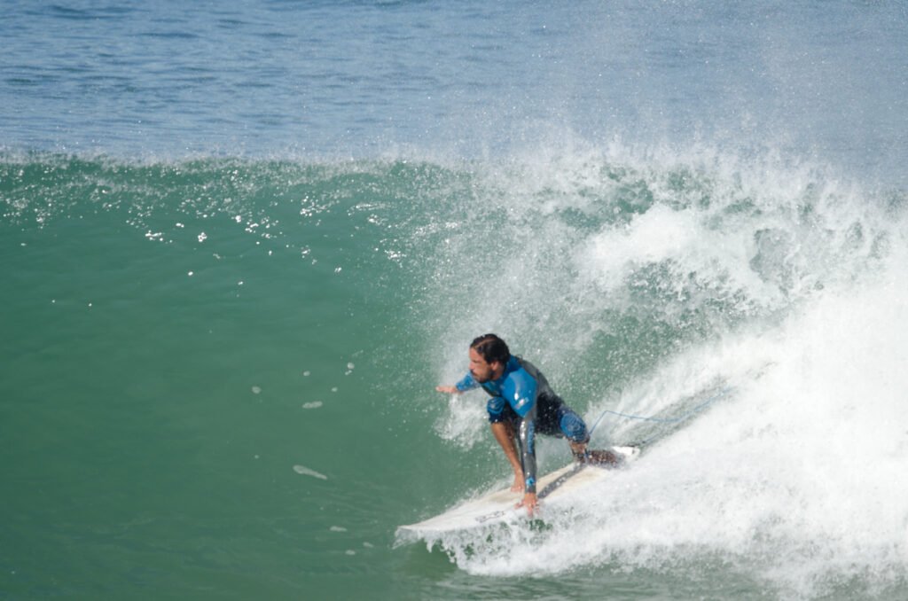 DSC_8468 Kite Maroc Essaouira Owner Majid surfing the face of a glassy wave in Morocco.