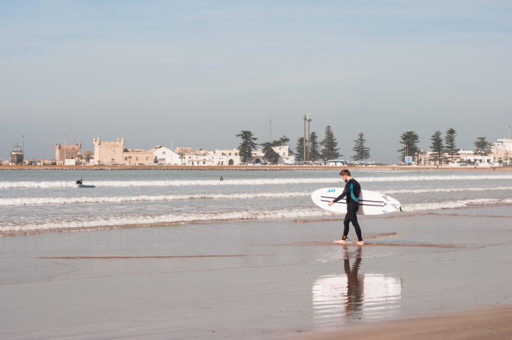 Surfer entering the water in Essaouira Morocco