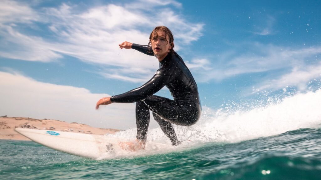Surfing action shot of a surfer on a wave, showcasing excitement and skill.
